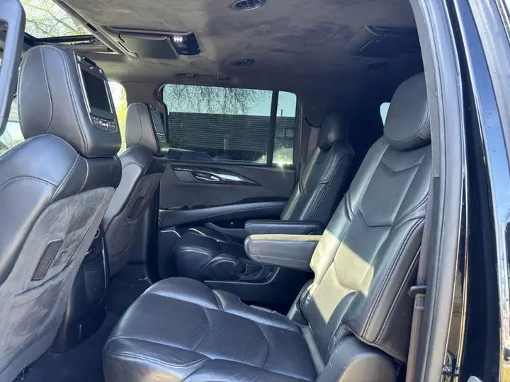 Cadillac Escalade second-row captain's chairs in black leather with rear-seat entertainment screens and center console