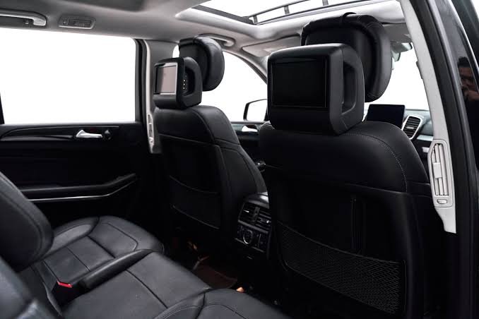 Mercedes SUV rear seat headrests with fold-down entertainment screens and black leather seating