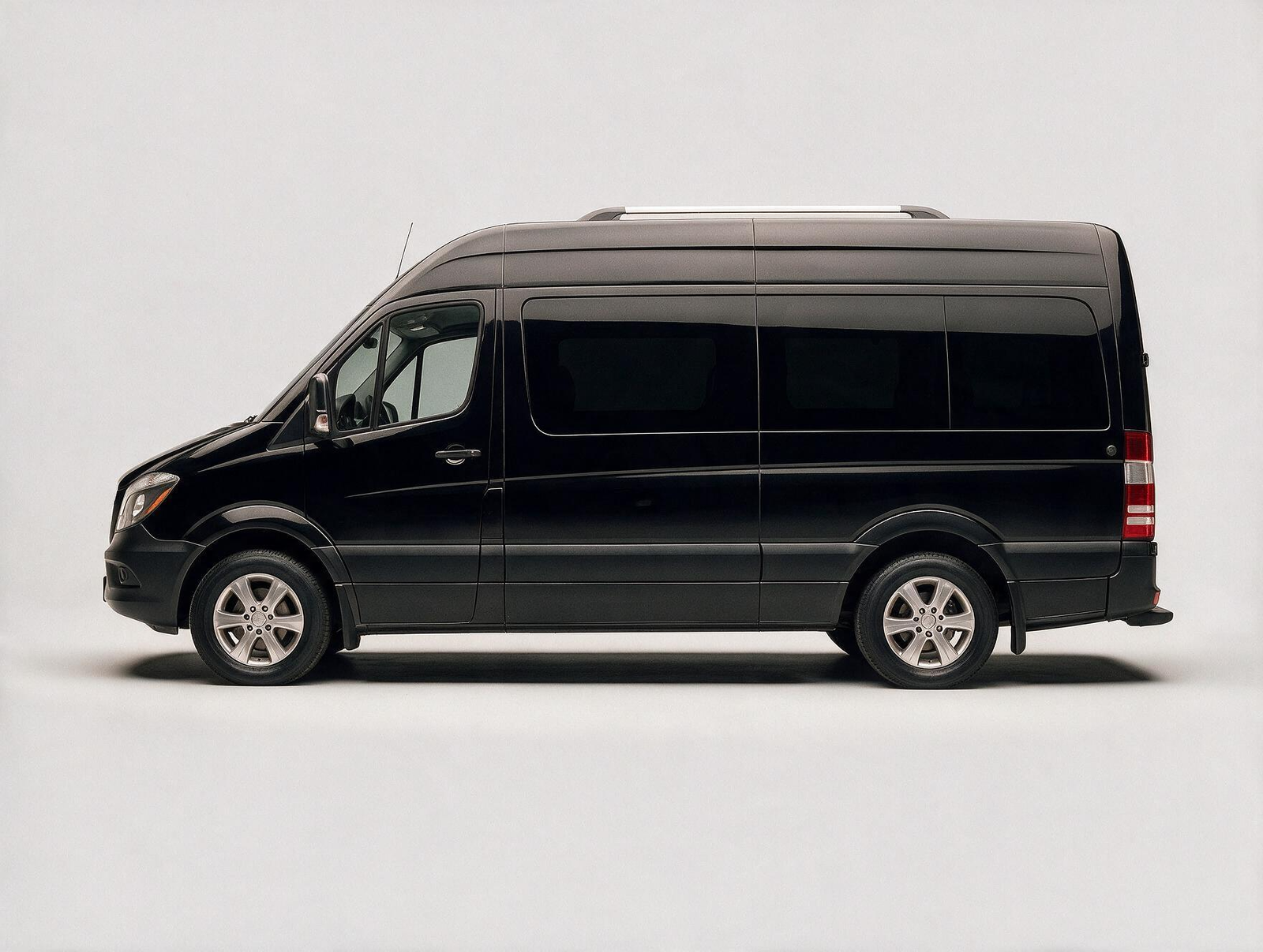 Black Mercedes-Benz Sprinter van front three-quarter view on white studio background