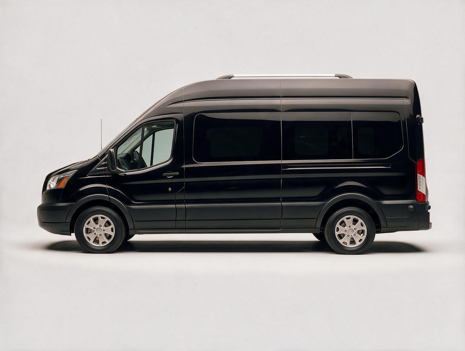 Black Ford Transit executive passenger van side profile on white background